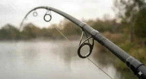 The ergonomic full shrink-wrap handle and reel seat of a modern 13ft carp fishing rod.