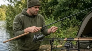 A versatile 3.25lb test curve carp rod being rigged with a standard lead clip setup for mid-range casting on a UK day-ticket water.