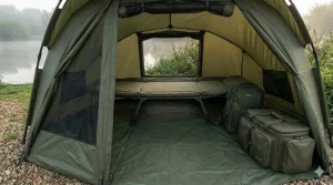 Interior view of a 1 man bivvy showing a standard carp bedchair and luggage fitting comfortably inside.