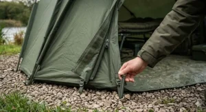 Illustration of a heavy-duty clip-in groundsheet being attached to a pram hood bivvy to keep out damp and rodents.