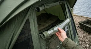 Diagram showing the versatile letterbox door system on a pram hood bivvy, allowing for visibility while staying protected from the rain.