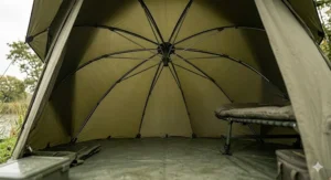 Interior view of a space-saver brolly system showing the compact central boss mechanism maximizing headroom above a fishing bedchair.