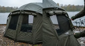 A carp bivvy overwrap with the outer fabric panels rolled up and secured, revealing large mozzy mesh vents for airflow during summer fishing sessions.