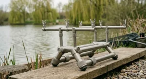 A fully assembled, lightweight carbon fibre and grey anodised aluminium hybrid rod pod, showing the master design language on a wooden plank.