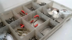 Tackle box organisation showing lures equipped with rubber treble hook protectors to prevent tangles.