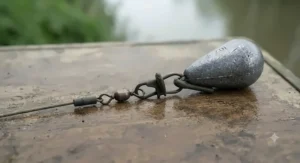 Streamlined gripper lead attached via a safety clip to a heavy-duty catfish rig for holding bottom in strong river currents.
