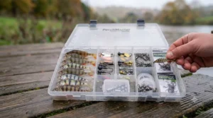A well-organised tackle box filled with a variety of small lures, jig heads, and terminal tackle for mobile perch anglers.