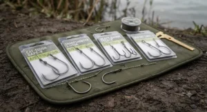 A selection of ultra-sharp, heavy-gauge catfish hooks ranging in size from 2/0 to 6/0 laid out to show gauge and gape.