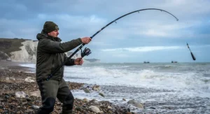 Angler demonstrating casting compression with a 13ft beachcaster rod to achieve greater casting distance over heavy surf.