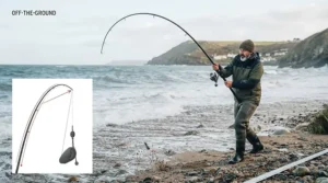 Sea angler demonstrating a powerful cast using a beachcaster rod for rough ground venues.